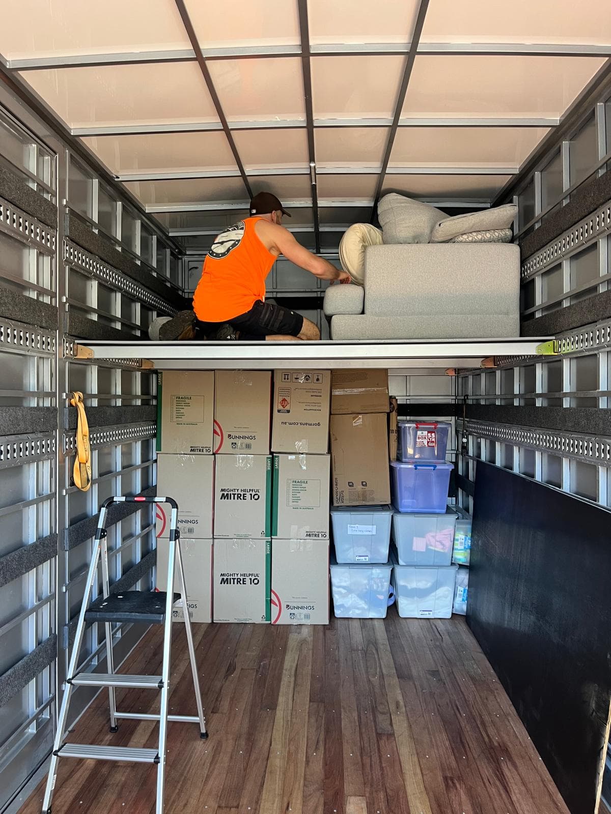 Crew loading a sofa onto a Ready To Move truck